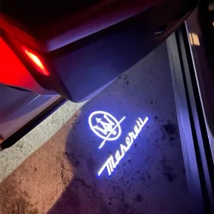 Maserati ghost lights projecting a sharp LED Trident logo onto the ground from the car door.